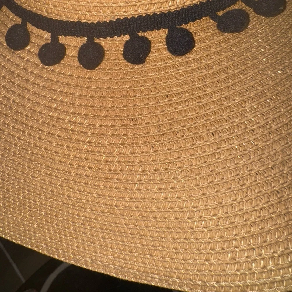 Hundred hearts straw oversized sun hat with black poms around the crown
